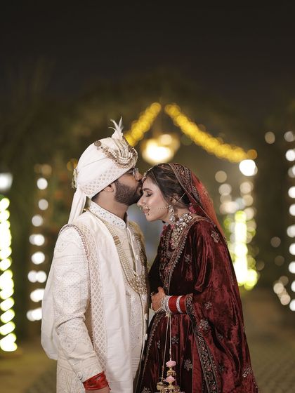 A perfect moment captured. For this bride's wedding, I created a timeless look with a velvet maroon lehenga, focusing on a glowing complexion and defined eyes that photographed beautifully.