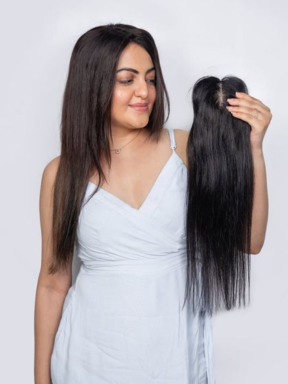 Thinning hair is a thing of the past with our Silk Topper. This model is holding the piece, showing the realistic scalp base that makes it blend so seamlessly for a fuller, natural look.