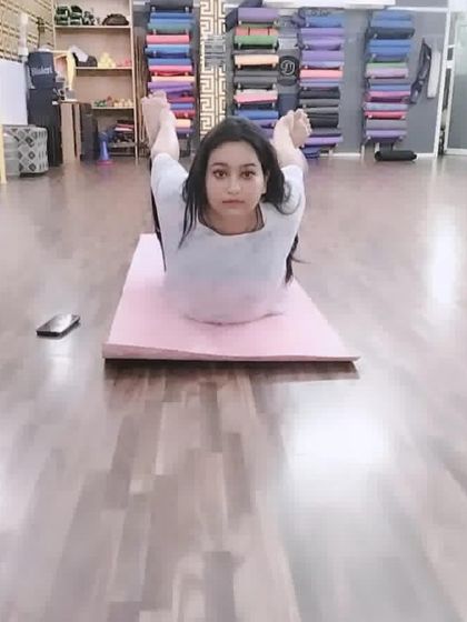 A very deep expression of Dhanurasana, the bow pose. This advanced backbend requires significant flexibility in the shoulders, chest, and quadriceps.