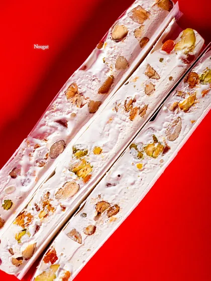 A close-up of the beautiful, jewel-like nuts and fruits inside the nougat.