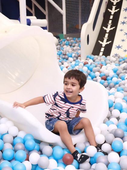 A perfect action shot of a happy kid landing from our spiral slide. The smile says it all, this is what pure, simple fun looks like.
