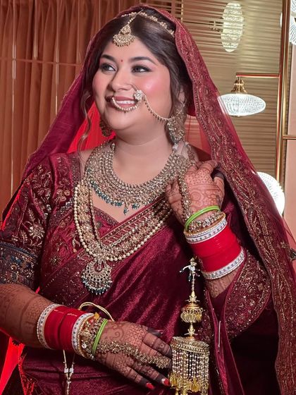 A candid moment of bridal happiness. The makeup is designed to be long-lasting and picture-perfect, ensuring she looks flawless throughout the festivities.