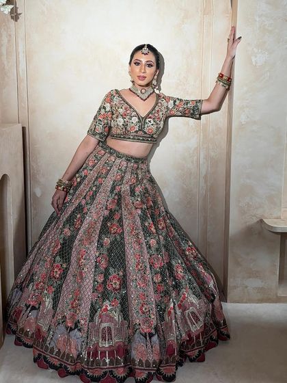 Another stunning view of the floral lehenga. The pose highlights the beautiful fall of the skirt and the intricate details of the blouse.