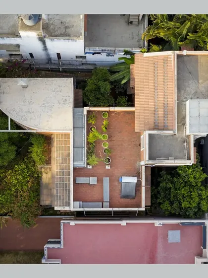 A top-down aerial view, revealing the building's footprint, the layout of the roofs, and its relationship with the neighboring properties.