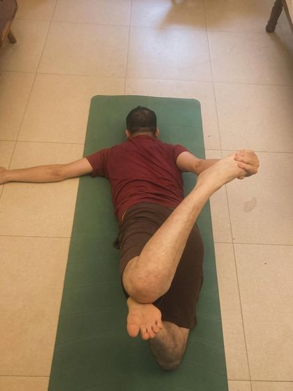 A personal class with my student Nivesh, surrounded by his three rescued indie cats. We're working on a reclined spinal twist to release his back.