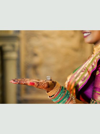 A creative close-up of the bride's hand showcasing her stunning engagement ring.