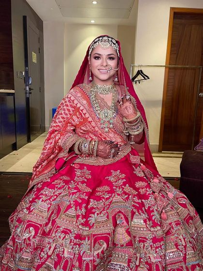 The complete bridal look, with the beautiful lehenga, stunning jewelry, and a perfect bridal bun.
