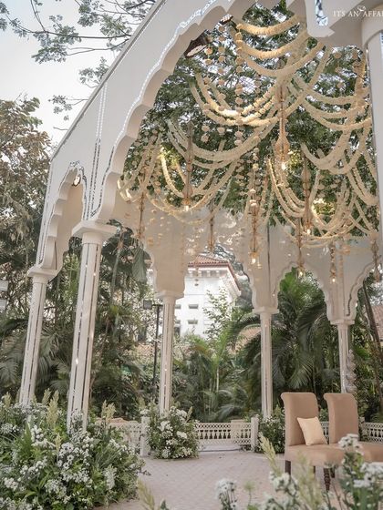 A side view of the mandap, showing the elegant pillars and the beautiful canopy of hanging tuberose garlands.