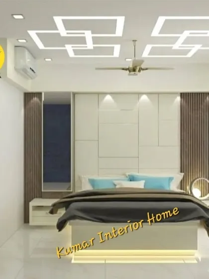 A modern bedroom with a unique geometric false ceiling design. The back wall features a combination of white panels and fluted wood accents, creating a contemporary and stylish look.