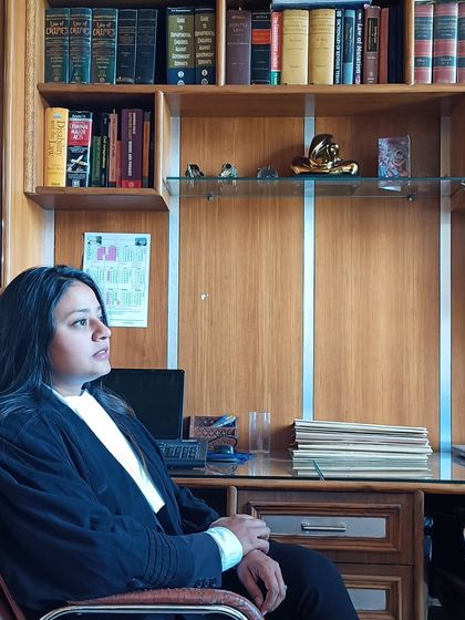 In my chamber, surrounded by law books. This is where strategies are born and cases are won, serving justice righteously with passion and skill.