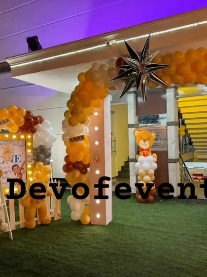 An outdoor entrance for a teddy bear party. I created a balloon arch with a star feature and set up a cute photo corner with a picket fence and a ladder full of teddy bears.