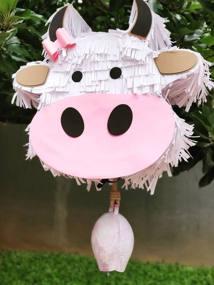 Fun and games are a must. This handmade cow piñata was a huge hit at the party, providing entertainment while perfectly matching the pink barnyard theme.