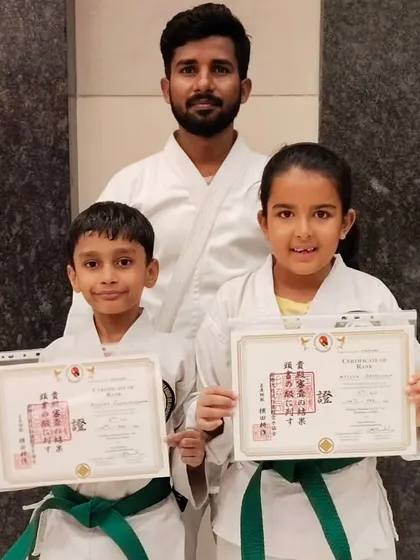 A brother and sister duo celebrating their new green belts. It's fantastic to see siblings train together, supporting each other as they learn and grow in their Shotokan Karate skills.