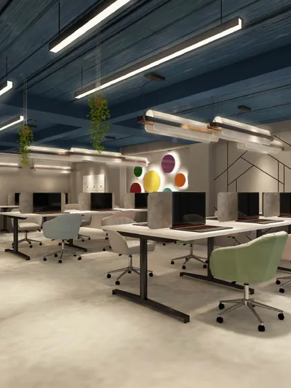 This minimalist office design features clean lines and a neutral color palette, with pops of color from the chairs and wall art. The open layout promotes focus, clarity, and efficiency.