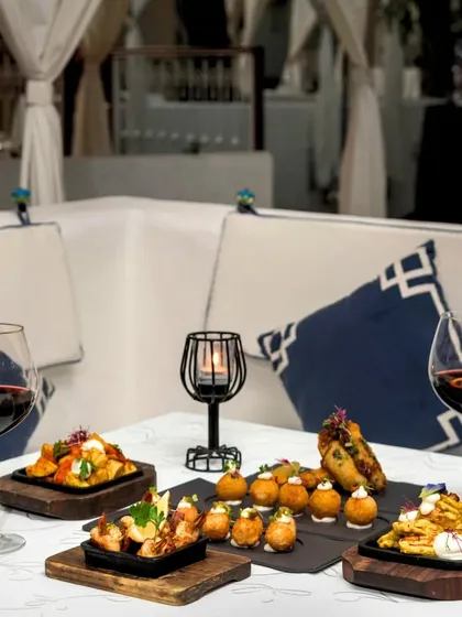 A cozy cabana setting with a selection of our popular tapas and sangria, perfect for a relaxed evening of sharing.