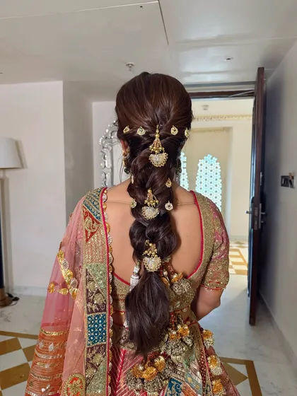 The full view of the stunning bridal braid with gold ornaments, a true statement piece.