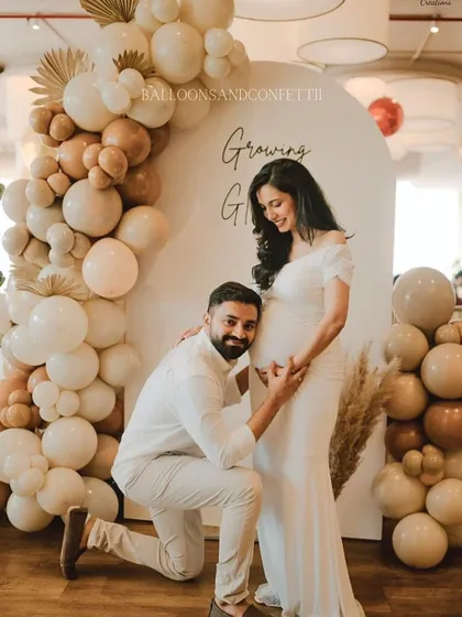 A beautiful moment captured. The parents-to-be are glowing in front of the 'Growing & Glowing' backdrop I designed for their baby shower.