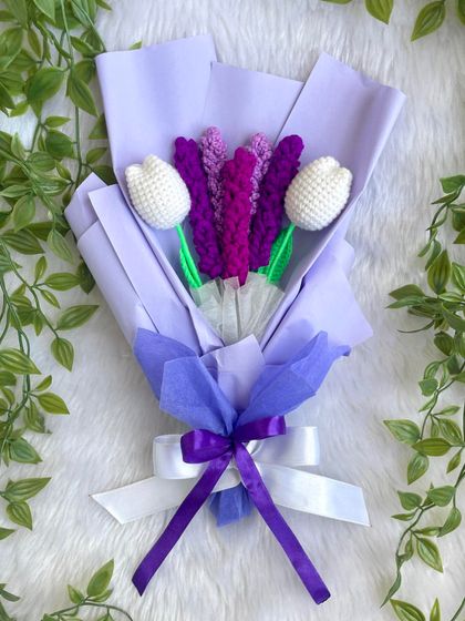 An elegant bouquet featuring crochet lavender and white tulips. The shades of purple in the wrapping create a calm and beautiful arrangement that is perfect for a special gift.
