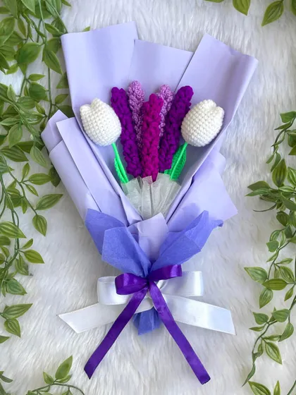 An elegant bouquet featuring crochet lavender and white tulips. The shades of purple in the wrapping create a calm and beautiful arrangement that is perfect for a special gift.