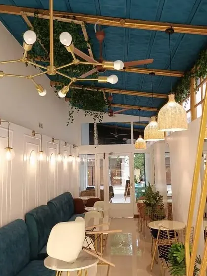 Lighting is crucial in setting the right mood. In this cafe, we layered multiple light sources, including a modern sputnik chandelier, woven pendant lamps, and classic wall sconces, to create a warm and dynamic ambience from day to night.
