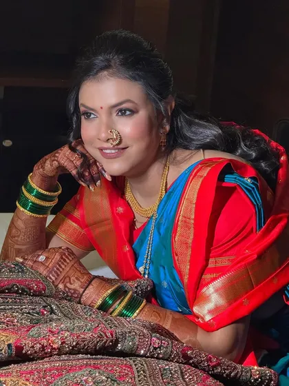 A candid moment of the bride, looking serene and beautiful. This shot captures the essence of the traditional Maharashtrian look, complete with green bangles and intricate jewelry.