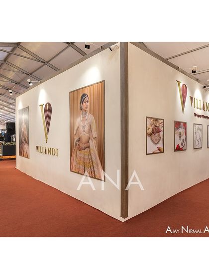 The exterior corner of the Villandi booth serves as a canvas for large-format campaign photography, connecting the architectural space with the brand's visual identity and storytelling.