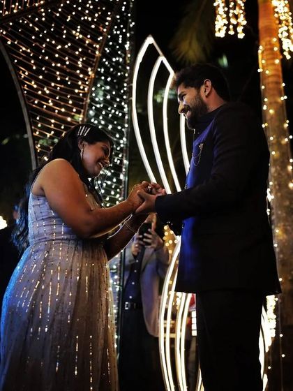 A candid shot capturing a moment of connection between the bride and groom, surrounded by fairy lights. It's these small moments that make a performance memorable.