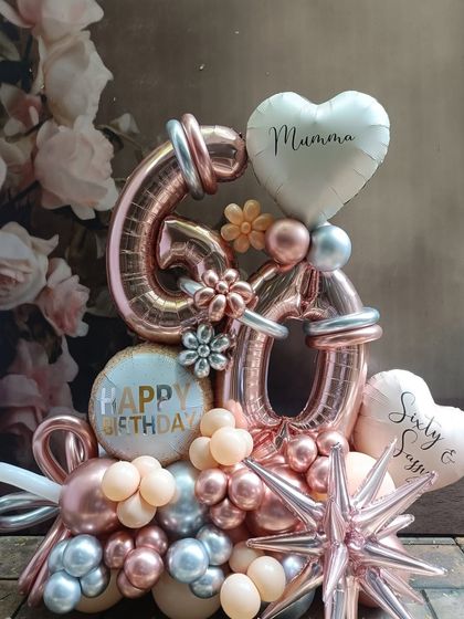 Celebrating 60 in style with this elegant rose gold and silver number bouquet. We personalized it with "Mummy" and "Sixty & Sassy" heart balloons to make it a truly special tribute for a milestone birthday.