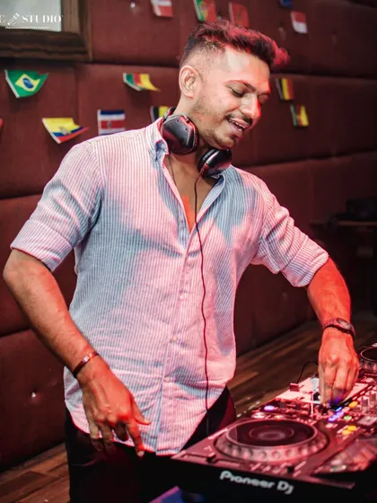 A candid shot of me enjoying the moment, mixing tracks with a smile. This is more than a job, it's my passion.