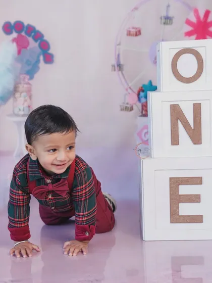 On the move and full of smiles, this crawling shot next to the "ONE" blocks captures a key milestone of his first year.