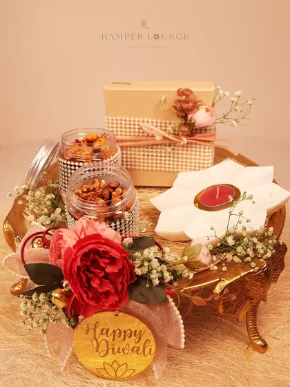 A closer look at the golden elephant tray Diwali hamper. You can see the detail in the packaging, from the jars of mixed nuts to the flower-shaped candle, all thoughtfully arranged to create a memorable gift.