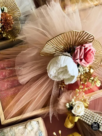 For me, trousseau packaging is an art. I combine elegant details like pastel net, artificial peonies and roses, and touches of gold to create a luxurious wrap for your wedding gifts that feels as special as the day itself.