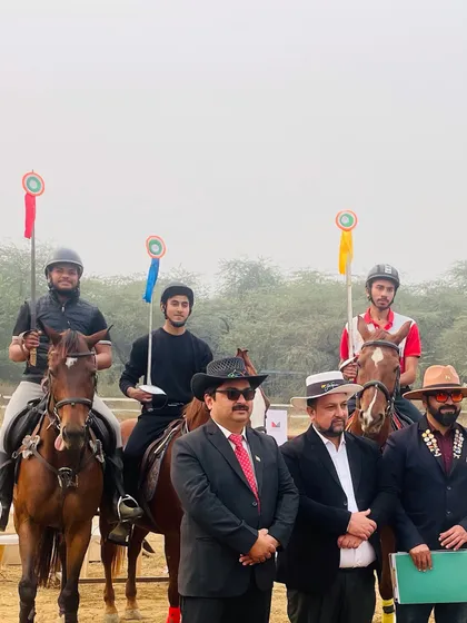 A front view of our winning riders and officials. Each rider holds a lance, representing their success in the tent pegging discipline.