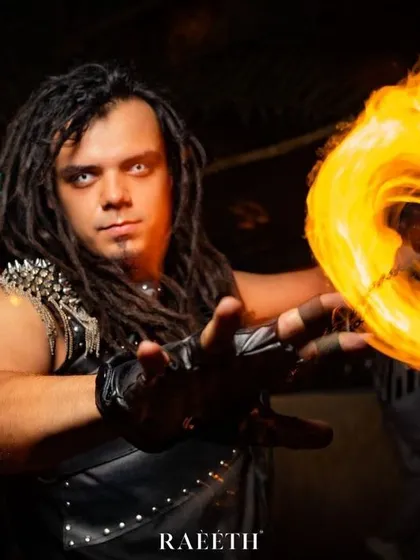 For us, fire is a conductor of emotion. This intense portrait captures a moment of connection between the artist and the flame, showcasing the focus and power of our male fire performers.