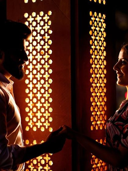 A moment of connection illuminated by the warm glow of a jali screen. This shot showcases my skill in using ambient light to create a moody and intimate atmosphere.