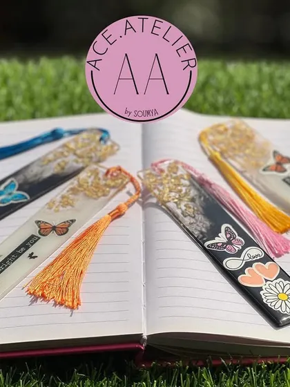 My custom resin bookmarks are perfect for any book lover. This image displays a variety of designs with butterflies, quotes, and colorful tassels.