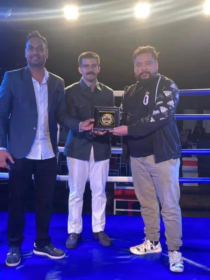 On stage receiving recognition for my contribution to professional boxing in Uttarakhand.
