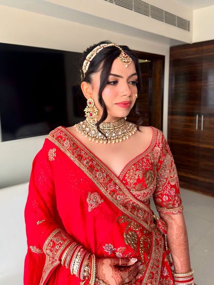 The side profile highlights the clean lines of the makeup and the intricate hairstyle.