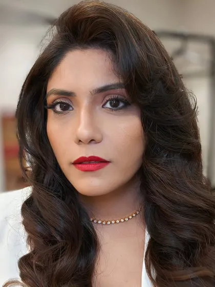 A confident, direct gaze that captures the essence of old Hollywood glamour. The hair and makeup work in perfect harmony to create a look that is both classic and striking.