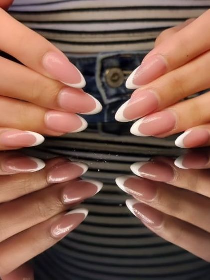 Another view of the flawless almond-shaped French manicure, highlighting the perfect curve of the white tips.