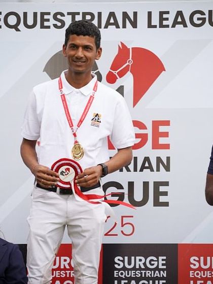 A rider from my team stands proudly on the podium after winning the Grand Prix Medium Tour at the Surge Show.