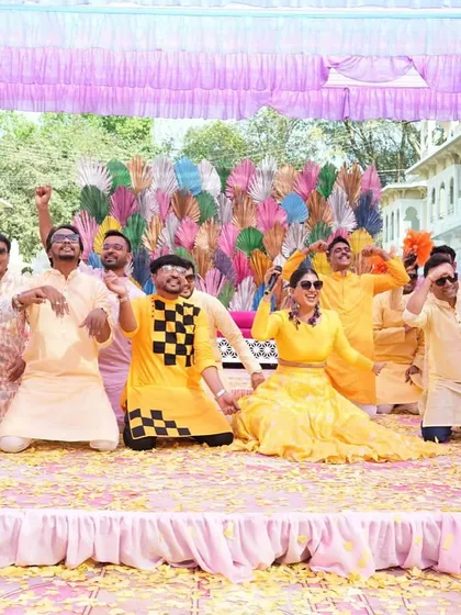 The whole group striking a pose at the end of a fun game. These photos capture the competitive and playful spirit of the Haldi event.