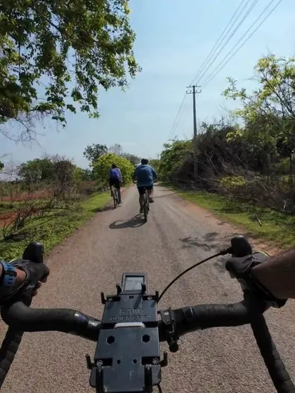 A POV shot from the handlebars, following two other riders on a peaceful country lane. It feels like you're right there with us.