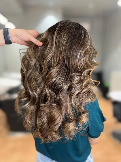 A butterscotch blonde balayage. This warm, rich blonde is perfect for adding a golden glow to your hair.