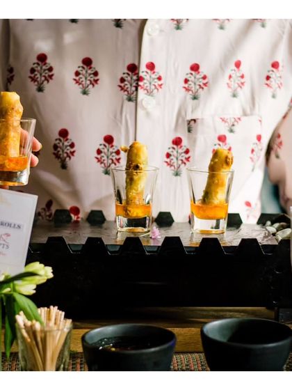 Thai spring rolls presented in shot glasses with dipping sauce. This image, a duplicate of ID 121, emphasizes our creative and practical presentation style.