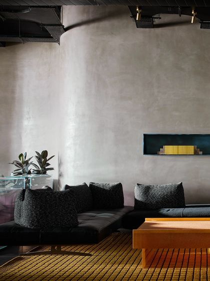 The minimalist side of the striped wall vignette, where a simple grey textured wall provides a calm counterpoint to the bold pattern.