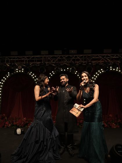 On stage with the happy couple, getting ready for a fun game. These interactive moments are what make a sangeet night truly personal and entertaining for everyone.