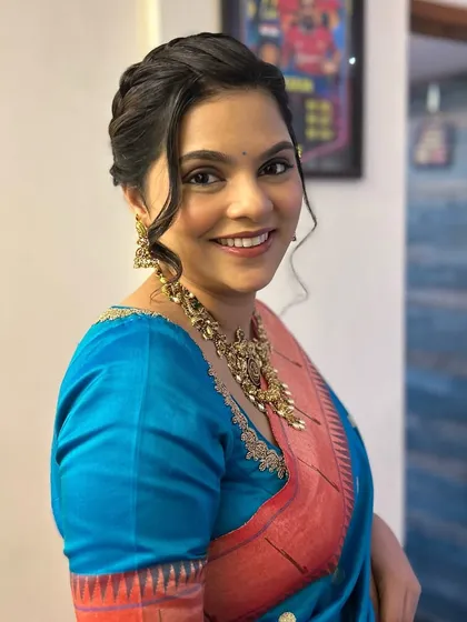 A happy and radiant client. The soft curls and glowing makeup are perfect for any special occasion.