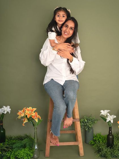 A sweet piggyback hug for mom. This portrait from my Mother's Day minis, set against a lovely floral backdrop, is full of warmth and affection.