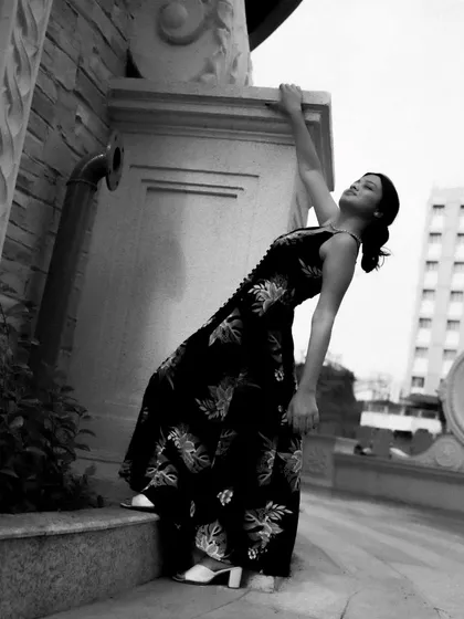 A black and white series exploring different poses against architectural elements. These shots focus on form, light, and the interaction between the subject and her environment.
